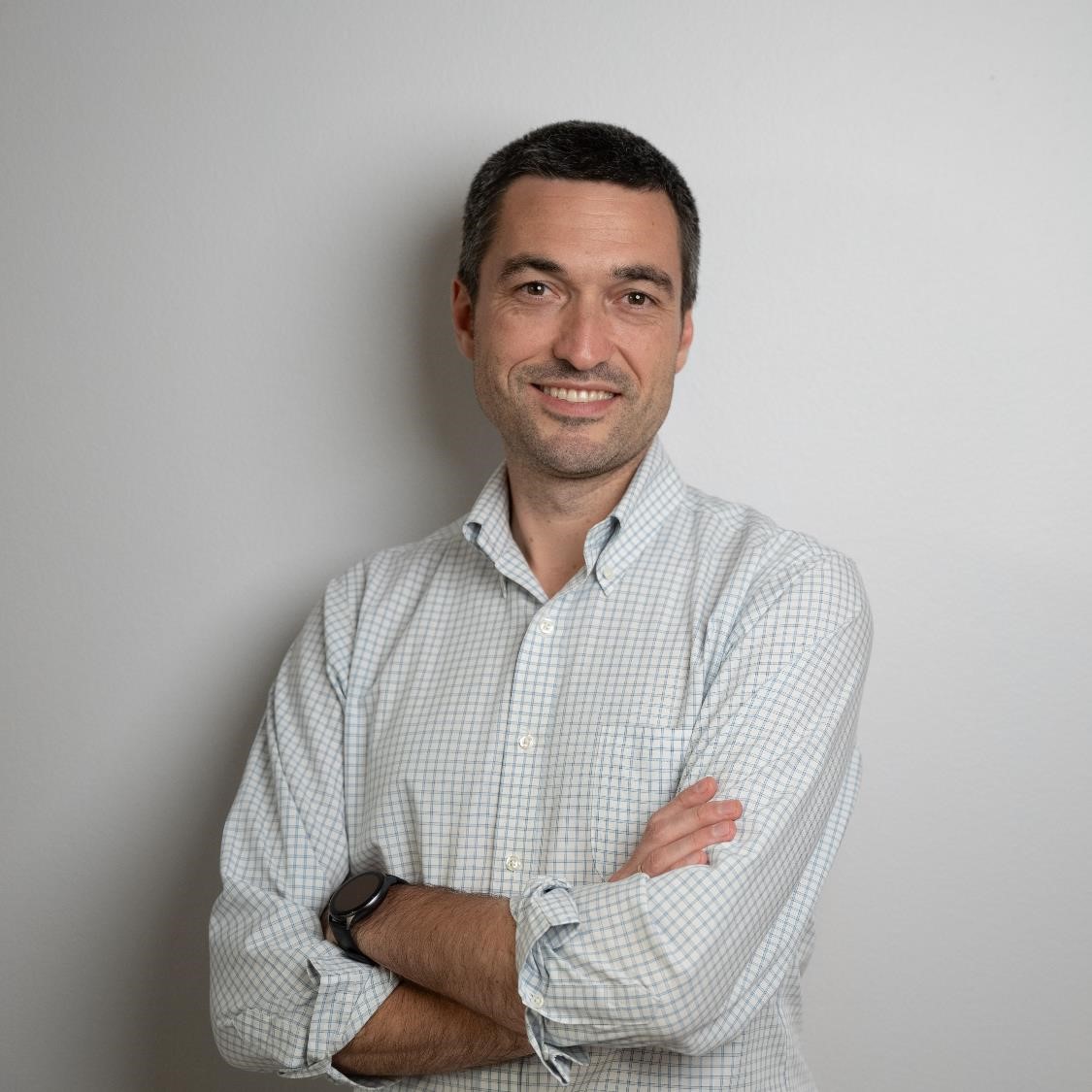 Professional studio portrait of Guillermo Beuchat, minimalist light background